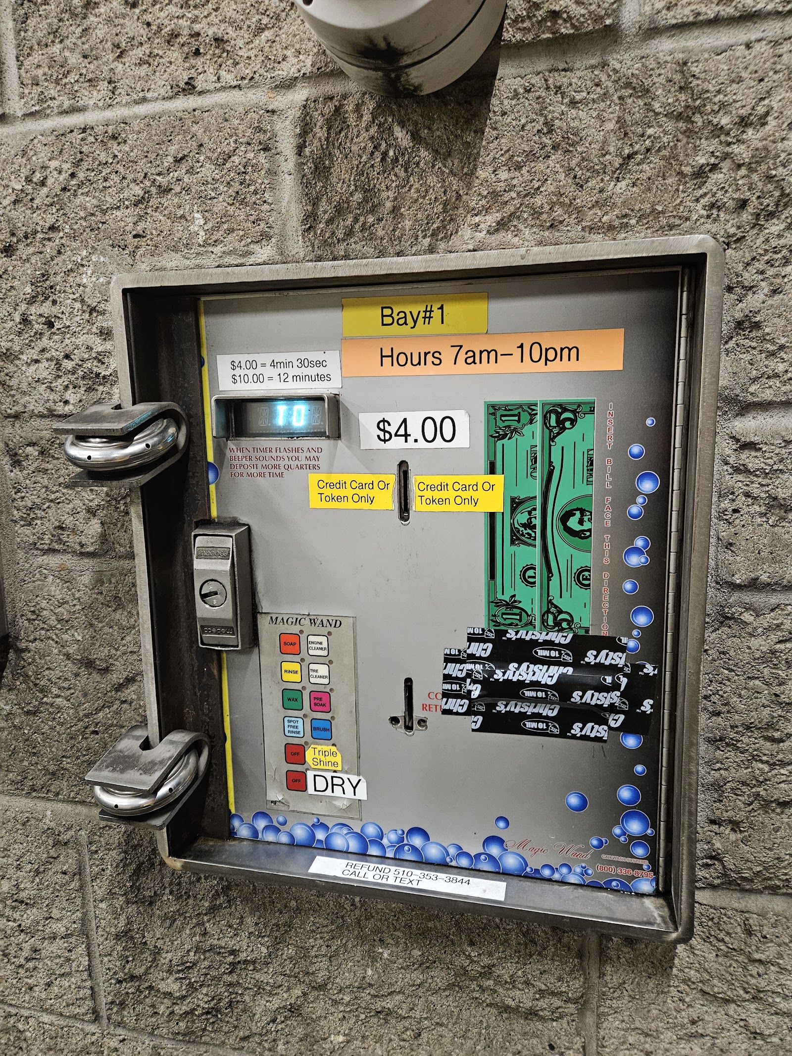 Close-up of the wall-mounted Magic Wand selector at Clear Water Car Wash, showing colored buttons for pre-soak, foam brush, rinse, tire cleaner, wax, spot-free rinse, and dry